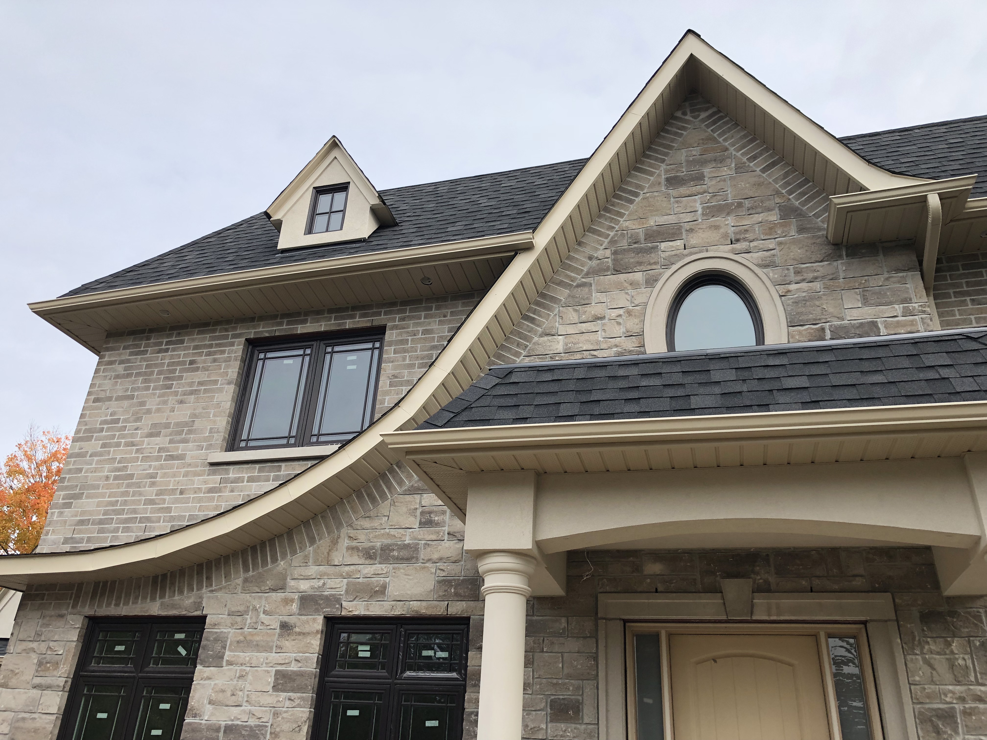 Close‑up of newly installed vented soffit panels and clean fascia trim on a Mississauga home, with siding visible below the roofline.