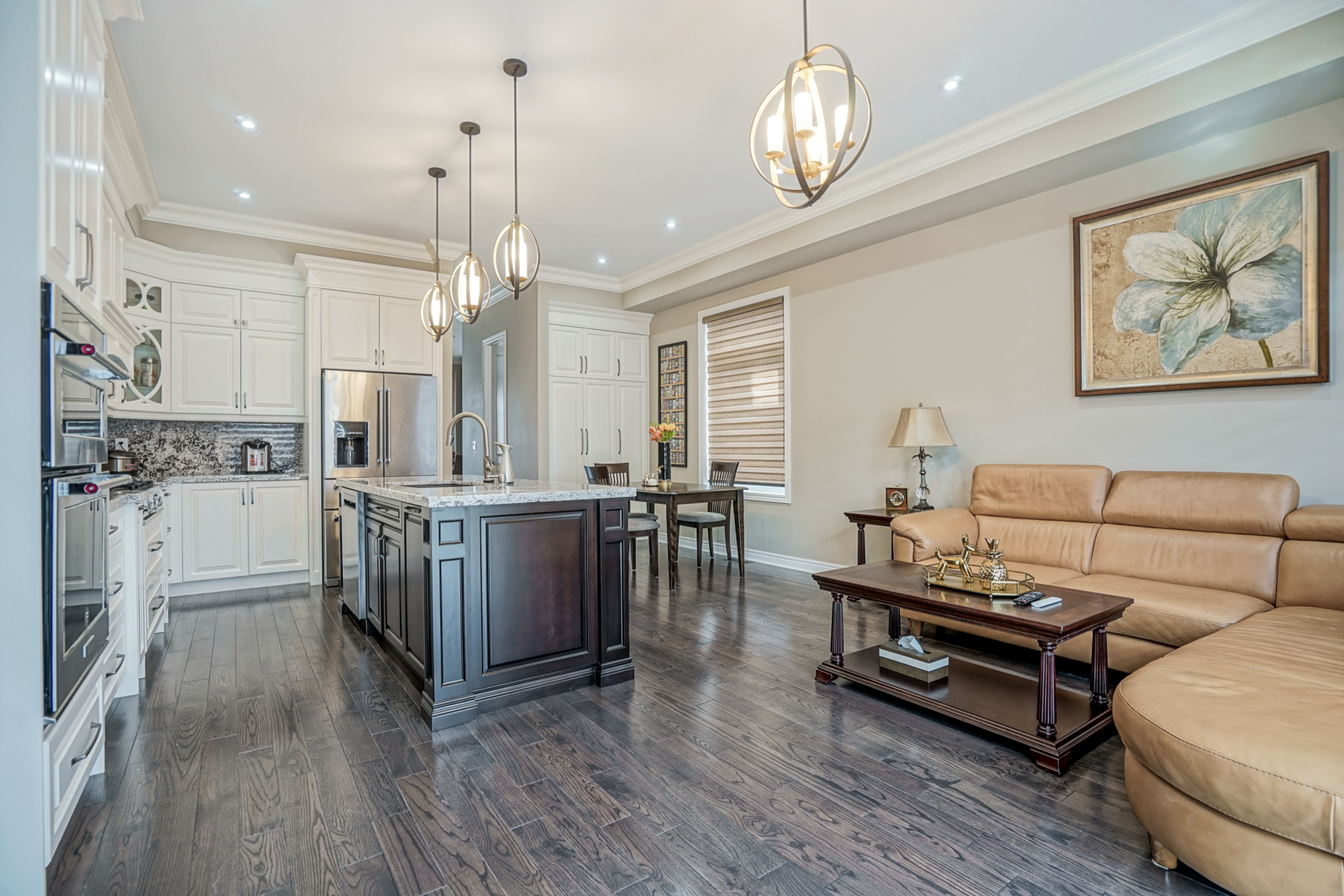 Modern kitchen with white cabinetry, marble backsplash, stainless steel gas range with pot filler, fluted upper cabinets, and open shelves displaying decorative items under warm accent lighting.