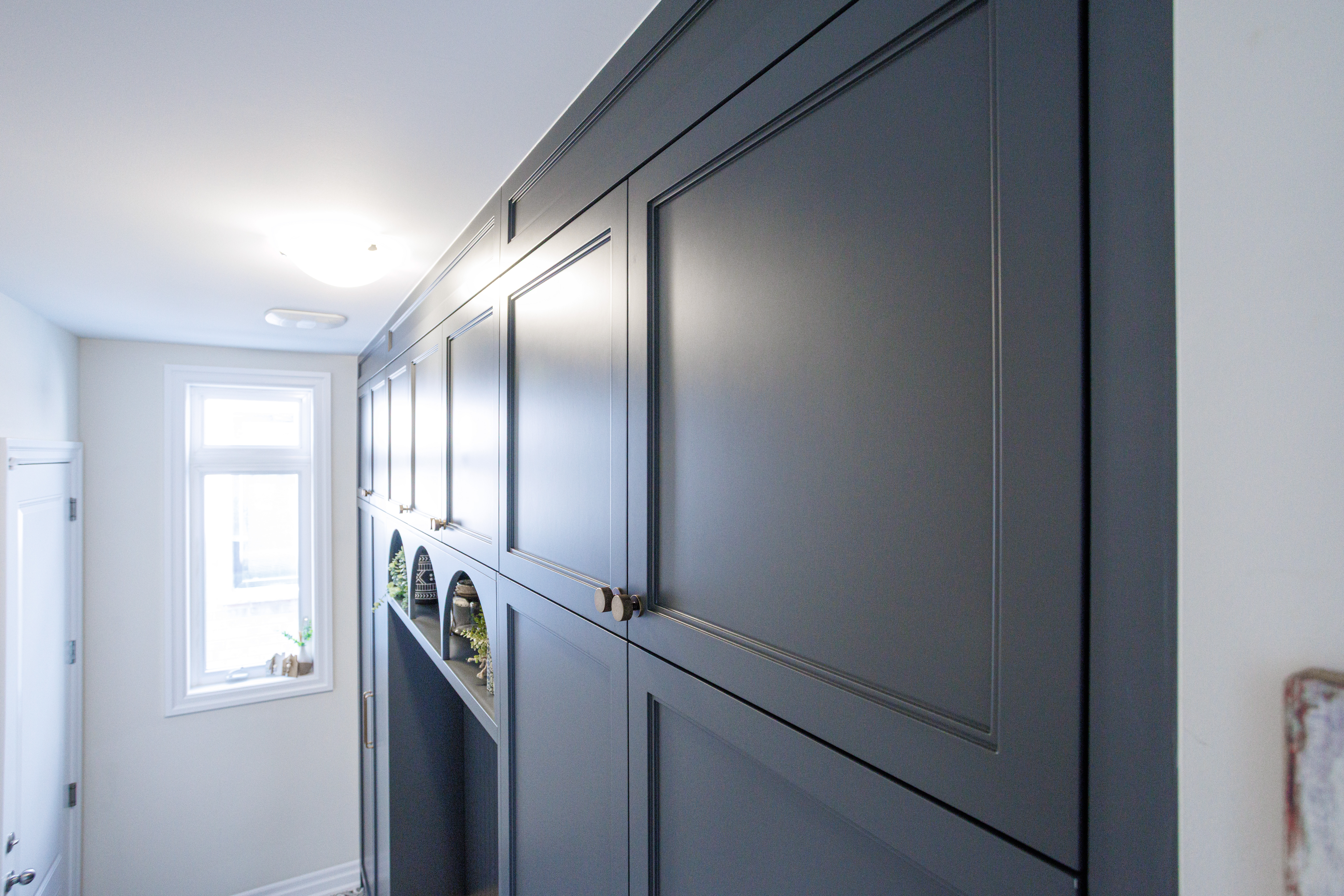 Custom built‑in cabinetry with matte dark grey doors.
